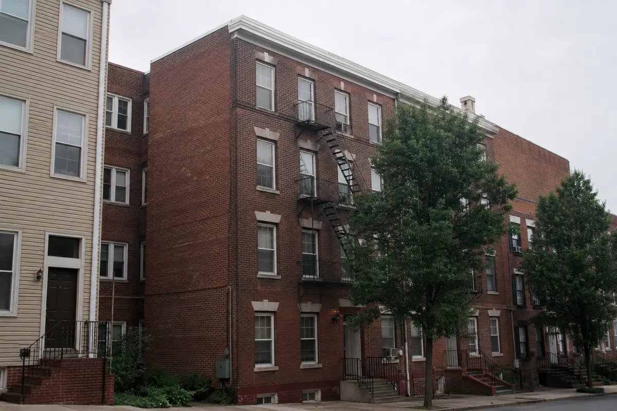 An older brick apartment building on an overcast Mid-Atlantic day